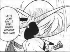 A pannel of the manga, where Yellow is adjusting the hat of her head, huging red's pikachu tightly. She says 'let's just say... I feel naked without this hat!'